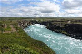 Godafoss, the waterfall of Gods: the small path along the river